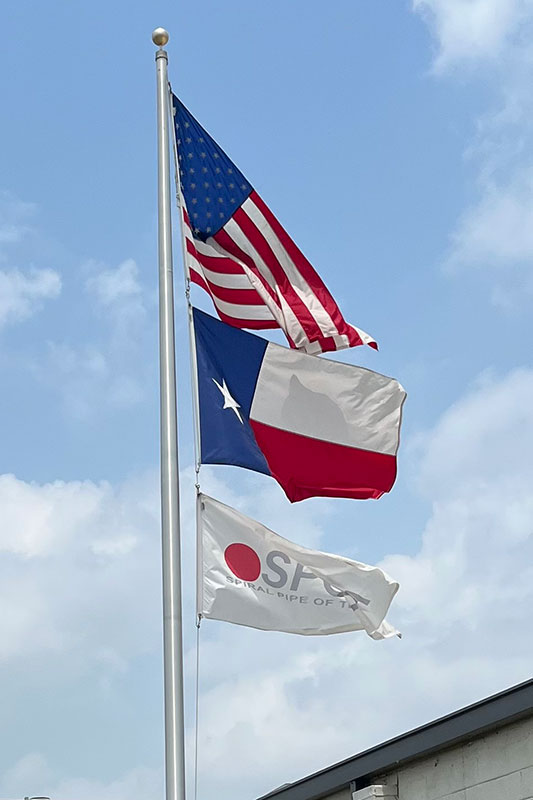 Flags Outside Cropped - Spiral Pipe of Texas